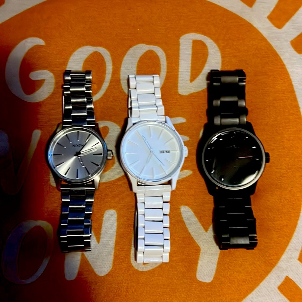 White, Silver, and Black Nixon unisex watches.
